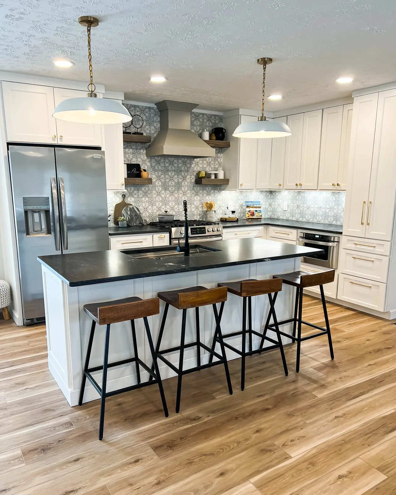 White kitchen with a black island and open shelving
