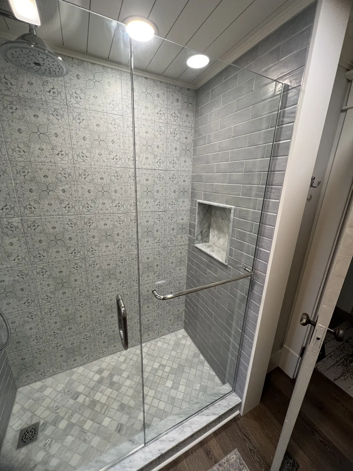 The same shower finished with a frameless glass door and panel