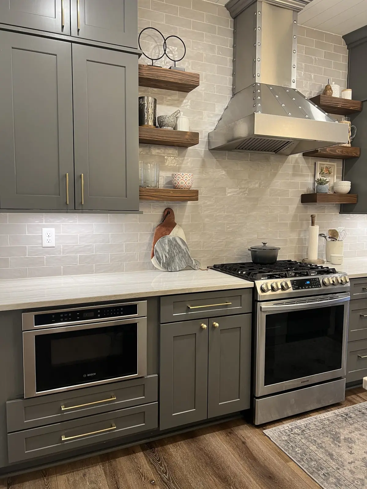 Gray cabinets, Morris and Co. backsplash tile and a stainless chimney hood