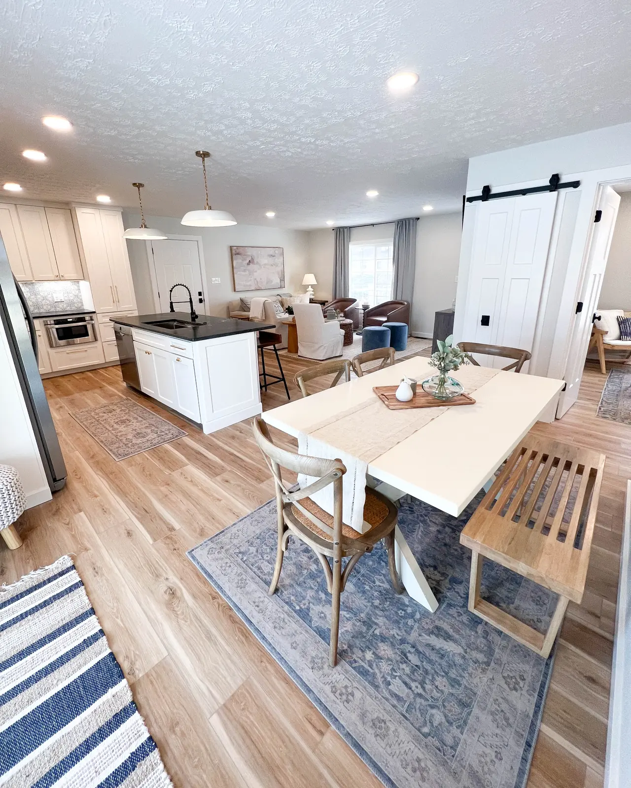 Open dining area with new wood-look flooring running into the kitchen